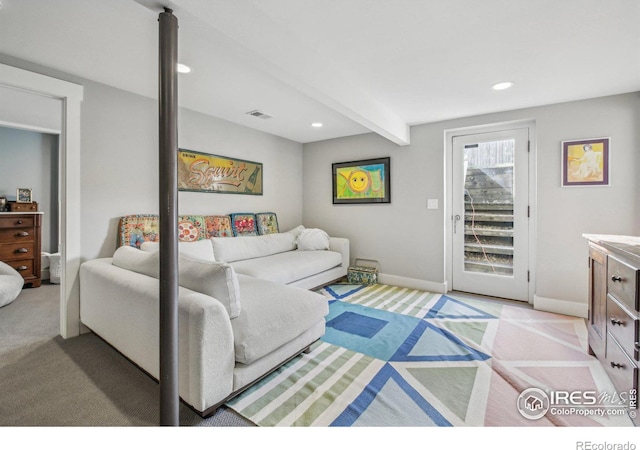 living room with beam ceiling and light colored carpet