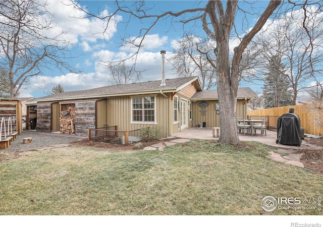 back of house featuring a patio area and a yard