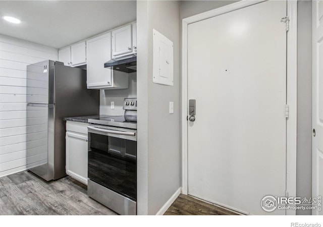 kitchen featuring appliances with stainless steel finishes, hardwood / wood-style flooring, and white cabinetry