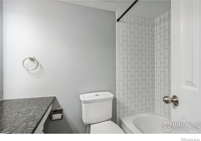 bathroom featuring tiled shower / bath and toilet