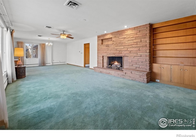 unfurnished living room with built in shelves, ceiling fan, a fireplace, and carpet