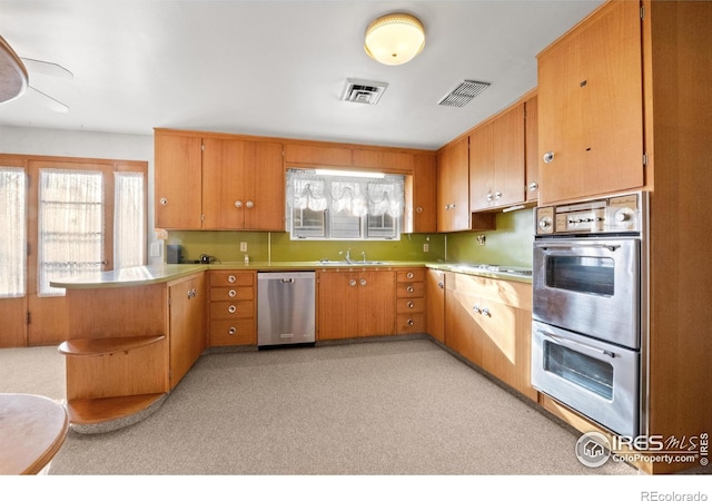 kitchen with sink, kitchen peninsula, and stainless steel appliances