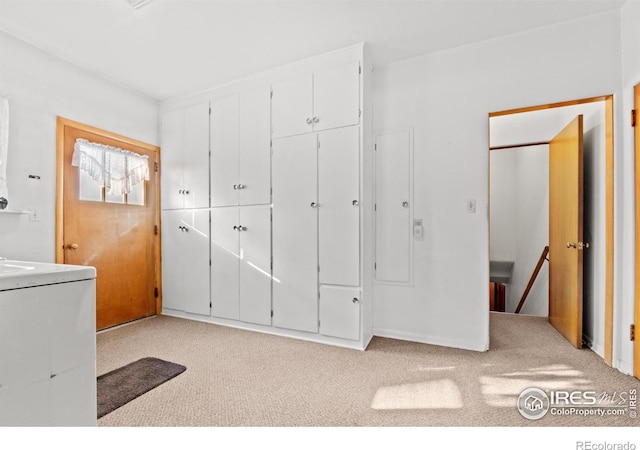 laundry room with light carpet and washer / clothes dryer