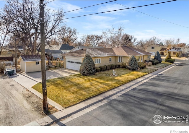 single story home with a front lawn and a storage unit