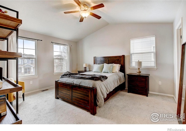 carpeted bedroom with ceiling fan and vaulted ceiling