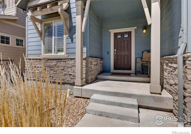 doorway to property featuring covered porch