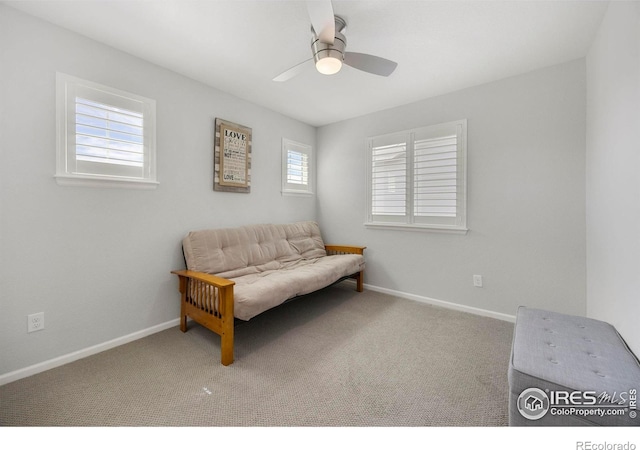 sitting room with carpet flooring and ceiling fan