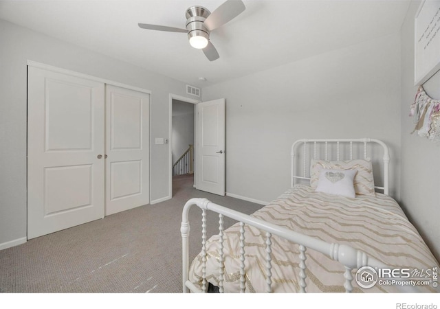 carpeted bedroom with a closet and ceiling fan