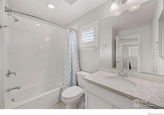 full bathroom featuring vanity, toilet, and shower / bath combo with shower curtain