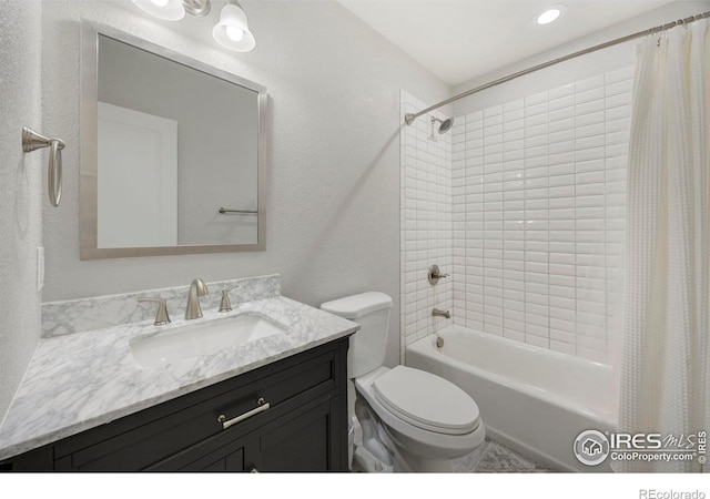 full bathroom with shower / tub combo with curtain, vanity, and toilet