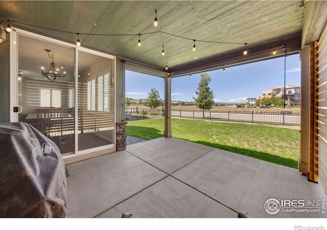 exterior space with a notable chandelier and wood ceiling