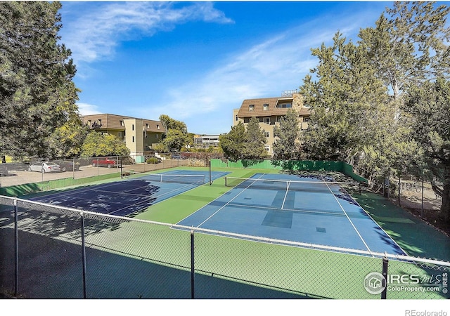 view of tennis court with fence