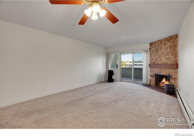 unfurnished living room featuring carpet, a fireplace, a textured ceiling, and baseboard heating