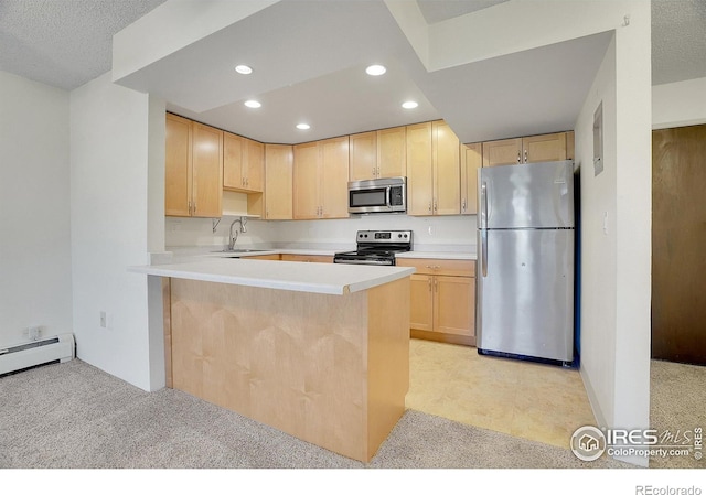 kitchen with appliances with stainless steel finishes, a peninsula, light brown cabinets, a sink, and recessed lighting