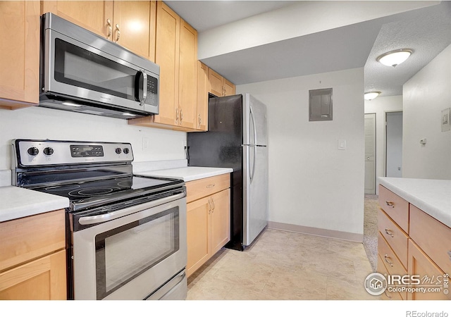 kitchen with appliances with stainless steel finishes, electric panel, light countertops, and light brown cabinetry