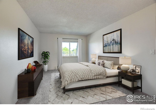 bedroom with carpet and a textured ceiling