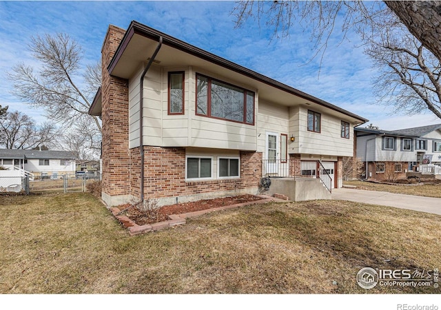 bi-level home with a front yard and a garage