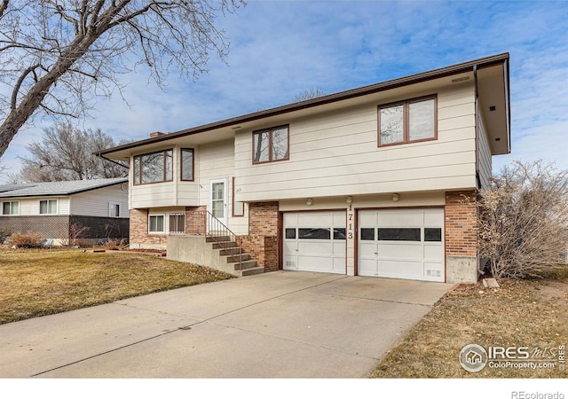 split foyer home featuring a garage and a front yard