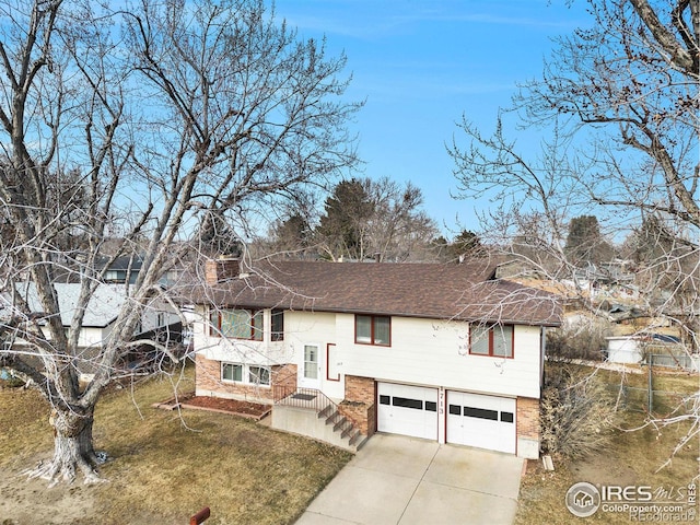 bi-level home featuring a garage and a front yard