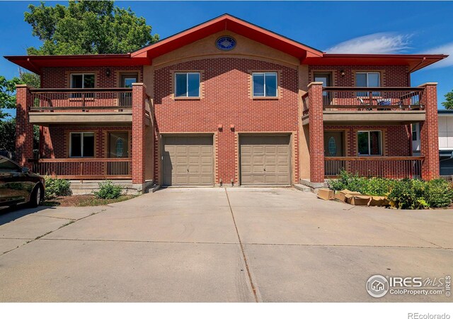 view of front of property with a balcony and a garage