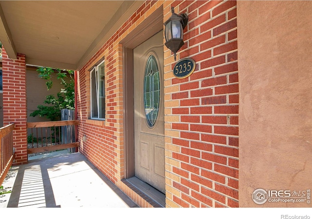 view of exterior entry with a porch