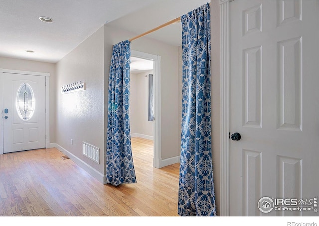 foyer entrance with hardwood / wood-style flooring