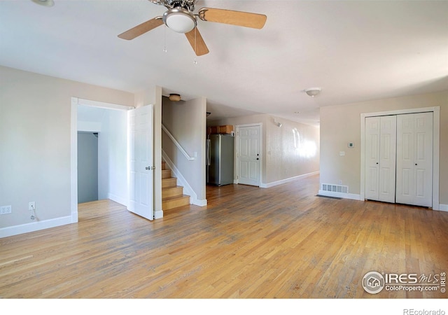 unfurnished living room featuring light hardwood / wood-style flooring and ceiling fan