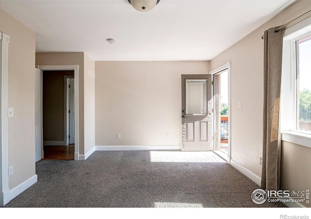 unfurnished bedroom with dark colored carpet