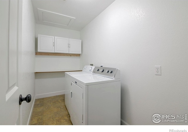 laundry area featuring washer and clothes dryer and cabinets