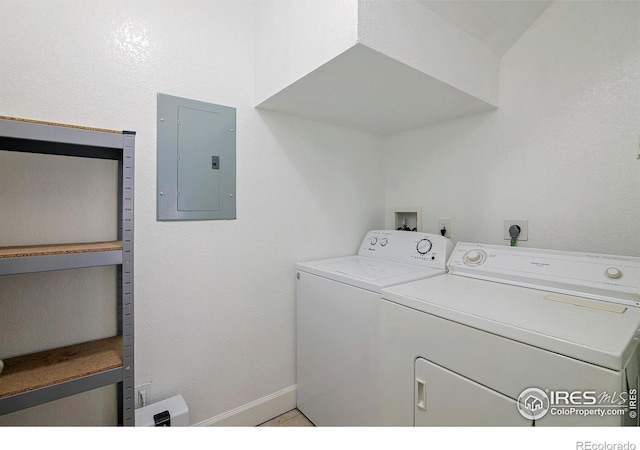 laundry room featuring washing machine and dryer and electric panel