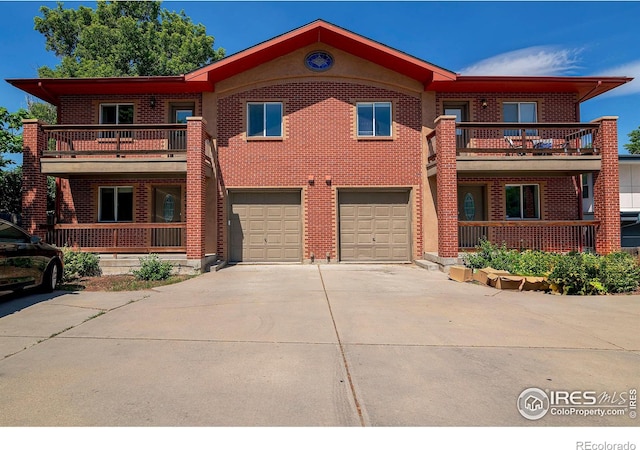 view of front of house featuring a garage and a balcony