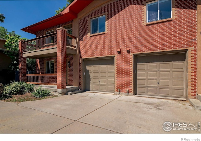 view of front of home featuring a balcony and a garage