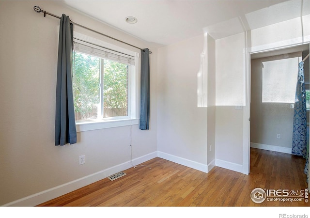 empty room featuring hardwood / wood-style flooring