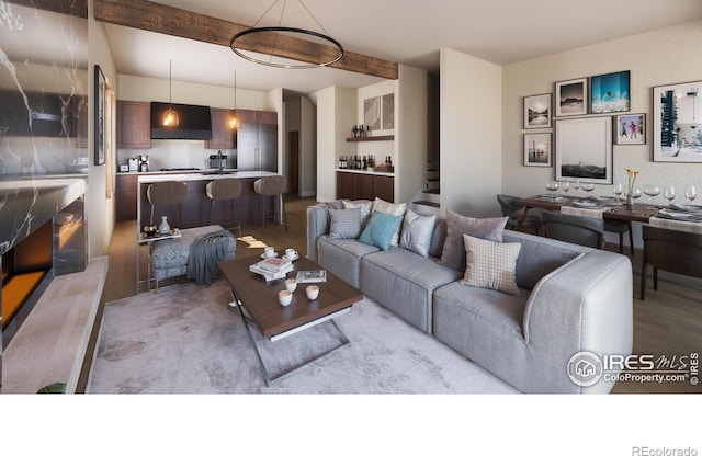 living room with sink, light hardwood / wood-style floors, and beamed ceiling