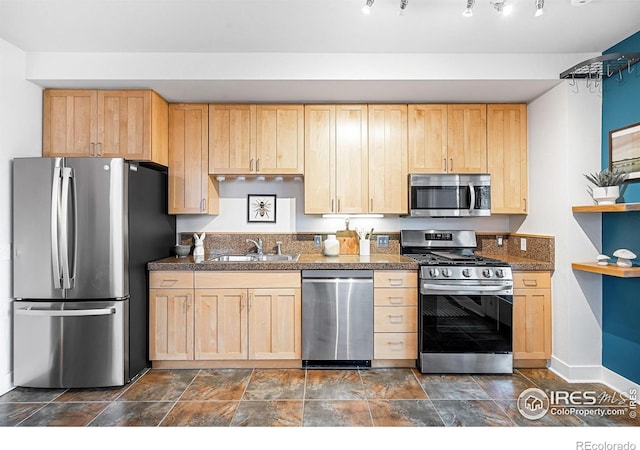 kitchen with sink, stainless steel appliances, and light brown cabinetry