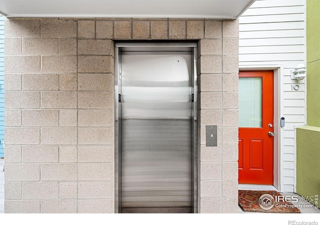 doorway to property featuring elevator