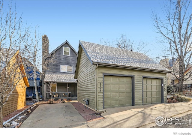 view of front facade with covered porch and a garage