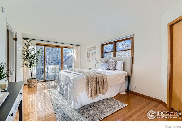 bedroom featuring access to exterior and light hardwood / wood-style floors