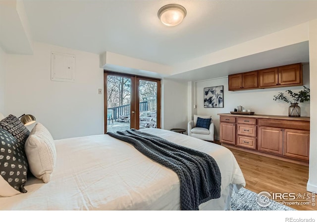 bedroom with light hardwood / wood-style floors, access to exterior, and french doors