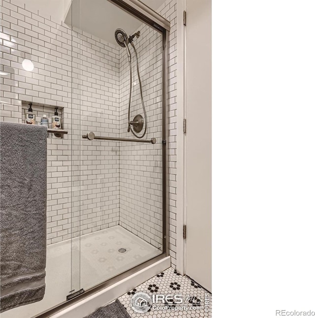 bathroom featuring tile patterned floors and a shower with door