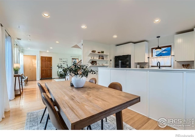 dining space with light wood-type flooring