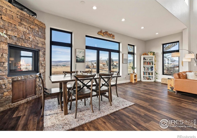 dining area with baseboards, dark wood-type flooring, and recessed lighting