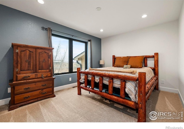 bedroom with light carpet, recessed lighting, and baseboards