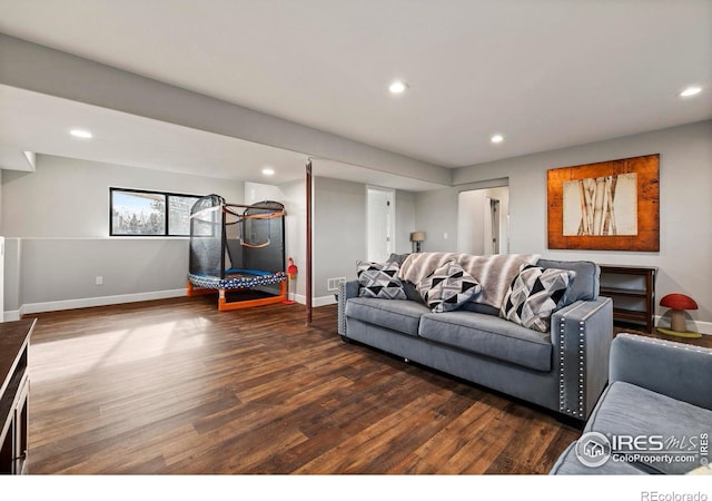 living area with recessed lighting, dark wood-style flooring, and baseboards