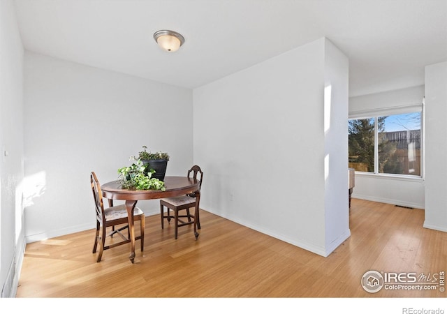 dining area featuring light wood-type flooring