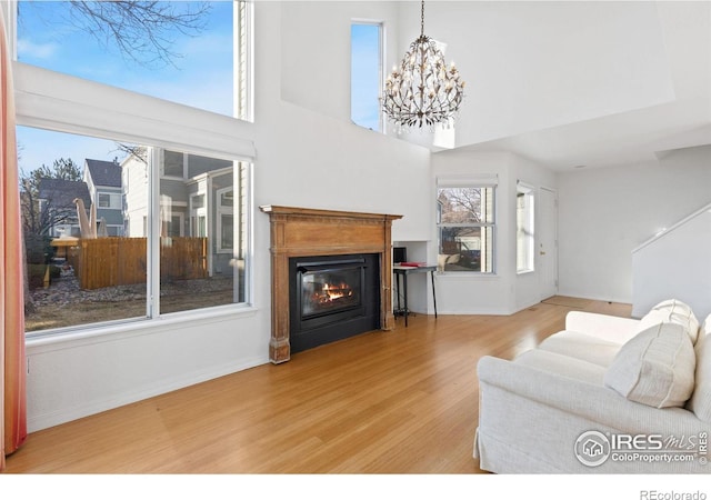 living room featuring hardwood / wood-style floors, an inviting chandelier, and a healthy amount of sunlight