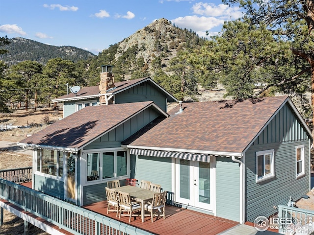 back of house featuring a deck with mountain view and french doors