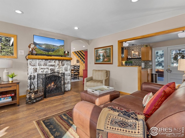 living room featuring a fireplace and light wood-type flooring