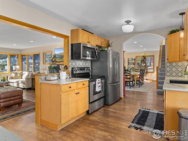 kitchen featuring decorative backsplash, dark hardwood / wood-style floors, and appliances with stainless steel finishes