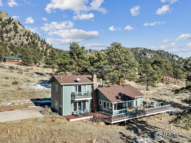 exterior space featuring a balcony and a deck